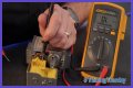 How do you test a Honeywell gas valve with a multimeter?